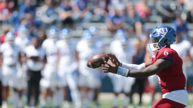Kansas junior quarterback Jalon Daniels (6) receives the ball during Saturday's spring game at David Booth Kansas Memorial Stadium.